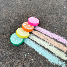 Load image into Gallery viewer, Colorful citrus-shaped chalk pieces on a concrete surface with chalk stripes.