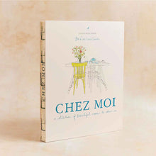 Load image into Gallery viewer, Book titled 'Chez Moi' with a cover illustration of a table and chairs on a beige background