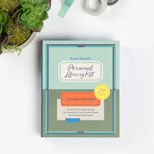 Load image into Gallery viewer, Knock Knock's Personal Library Kit on a white surface with a plant in the corner.