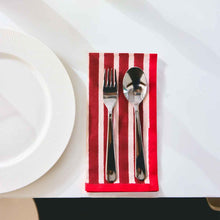 Load image into Gallery viewer, Silver fork and spoon on a red and white striped napkin with a white plate in the background.