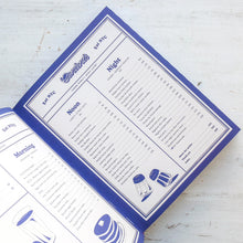 Load image into Gallery viewer, Blue and white planner with daily schedule on a light wooden surface