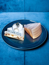 Load image into Gallery viewer, Decorative cheese next to a parmiggiano cheese on a blue plate with a blue background
