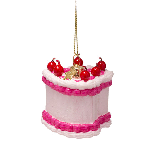 Decorative cake ornament with red cherries and pink trim on a white background