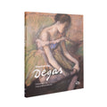 Book cover of 'Discovering Degas' with an illustration of a dancer massaging her angle on a white background