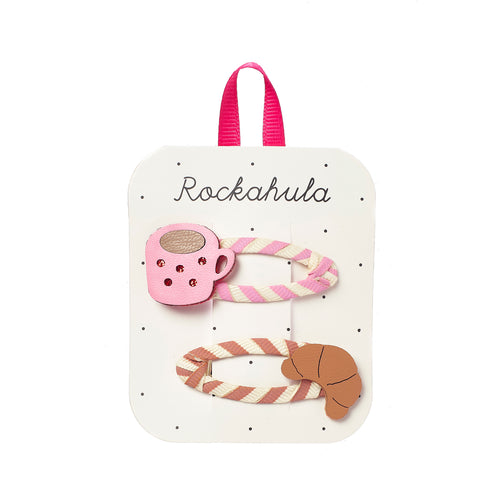 Set of hair clips with a pink teacup design on a white card with 'Rockahula' branding.