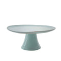Light blue ceramic cake stand on a white background