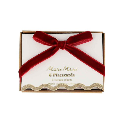 Box of Meri Meri placecards with a red ribbon on a white background
