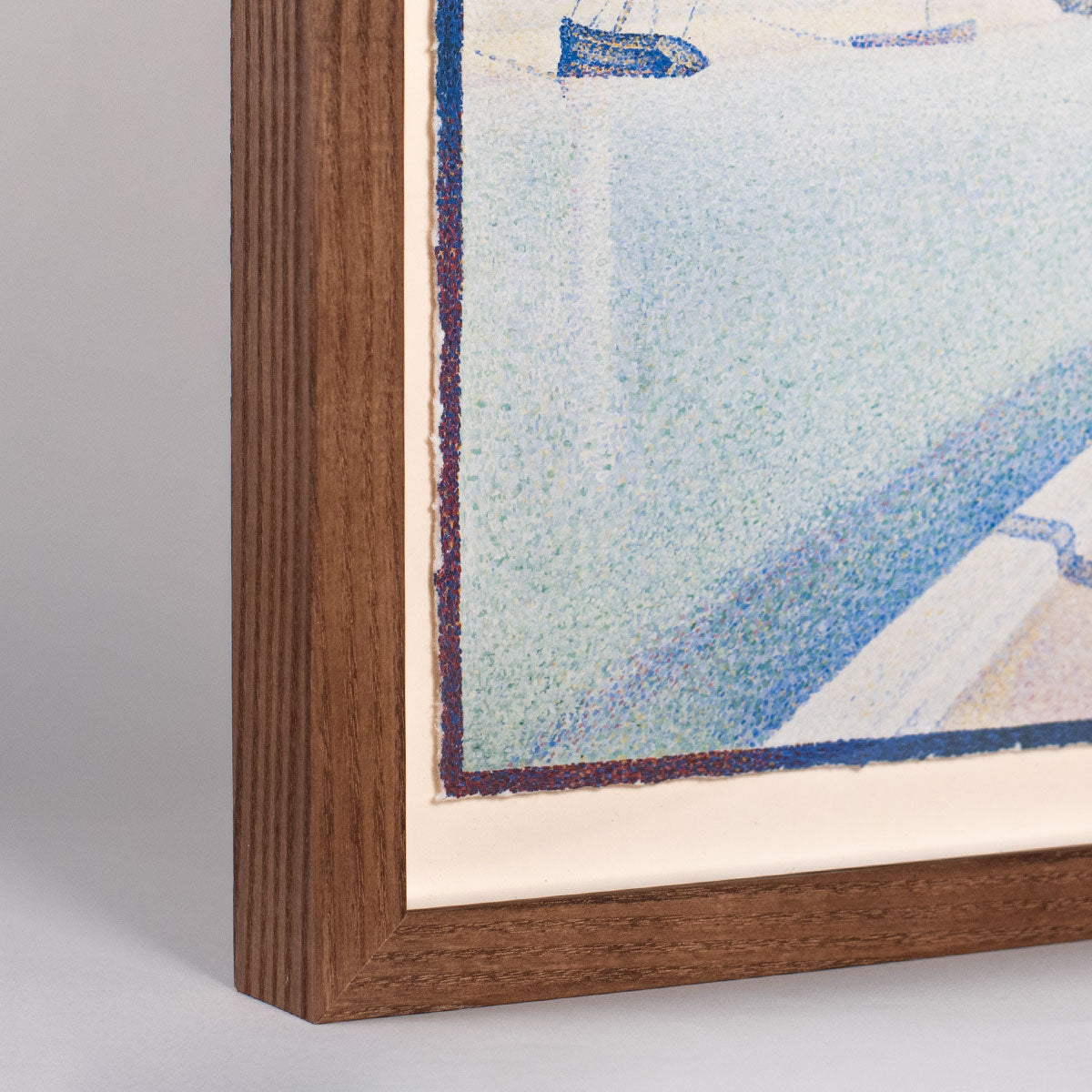 Close-up of a framed abstract painting with a wooden frame.