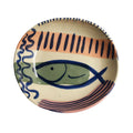 Ceramic plate with fish design on a white background