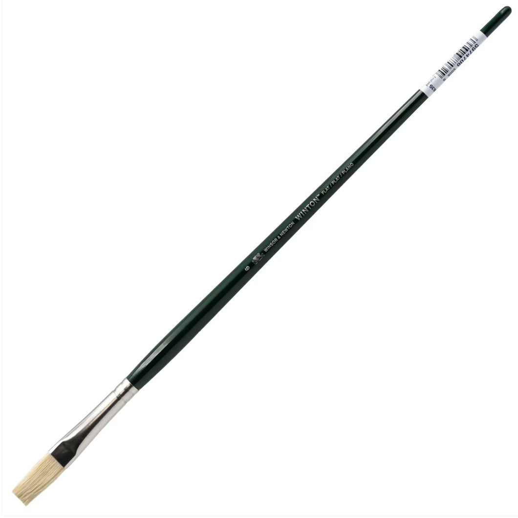 Paintbrush with green handle and white bristle head on a white background