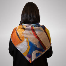 Load image into Gallery viewer, Person wearing a colorful scarf with abstract design on a plain background
