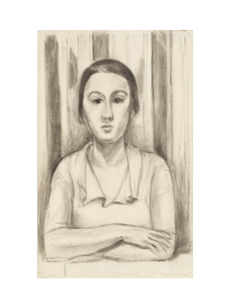 A Woman with her arms on a table