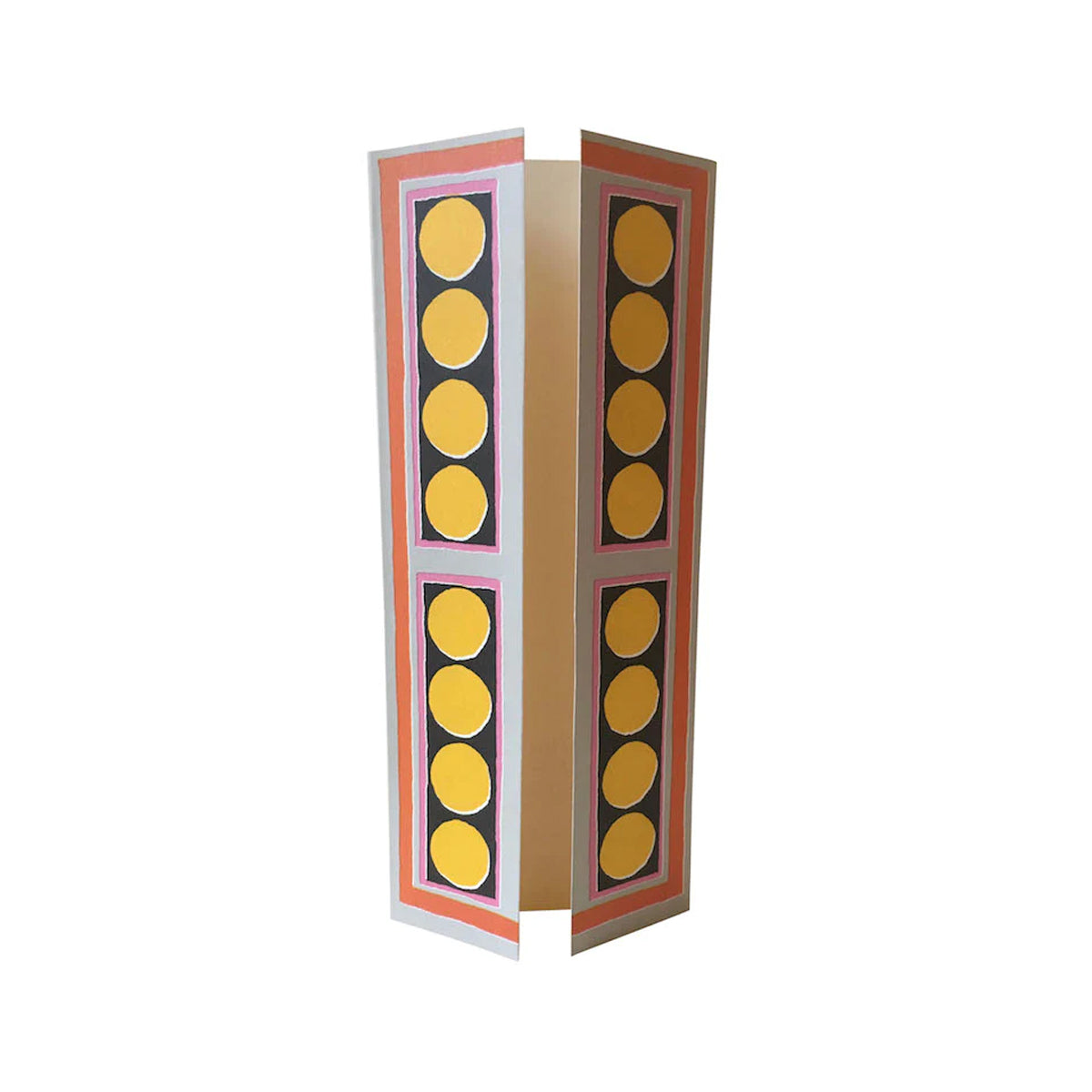 A tall foldable greeting card with geometric patterns, predominantly yellow circles, on the front flap. The card is standing upright against a plain background.