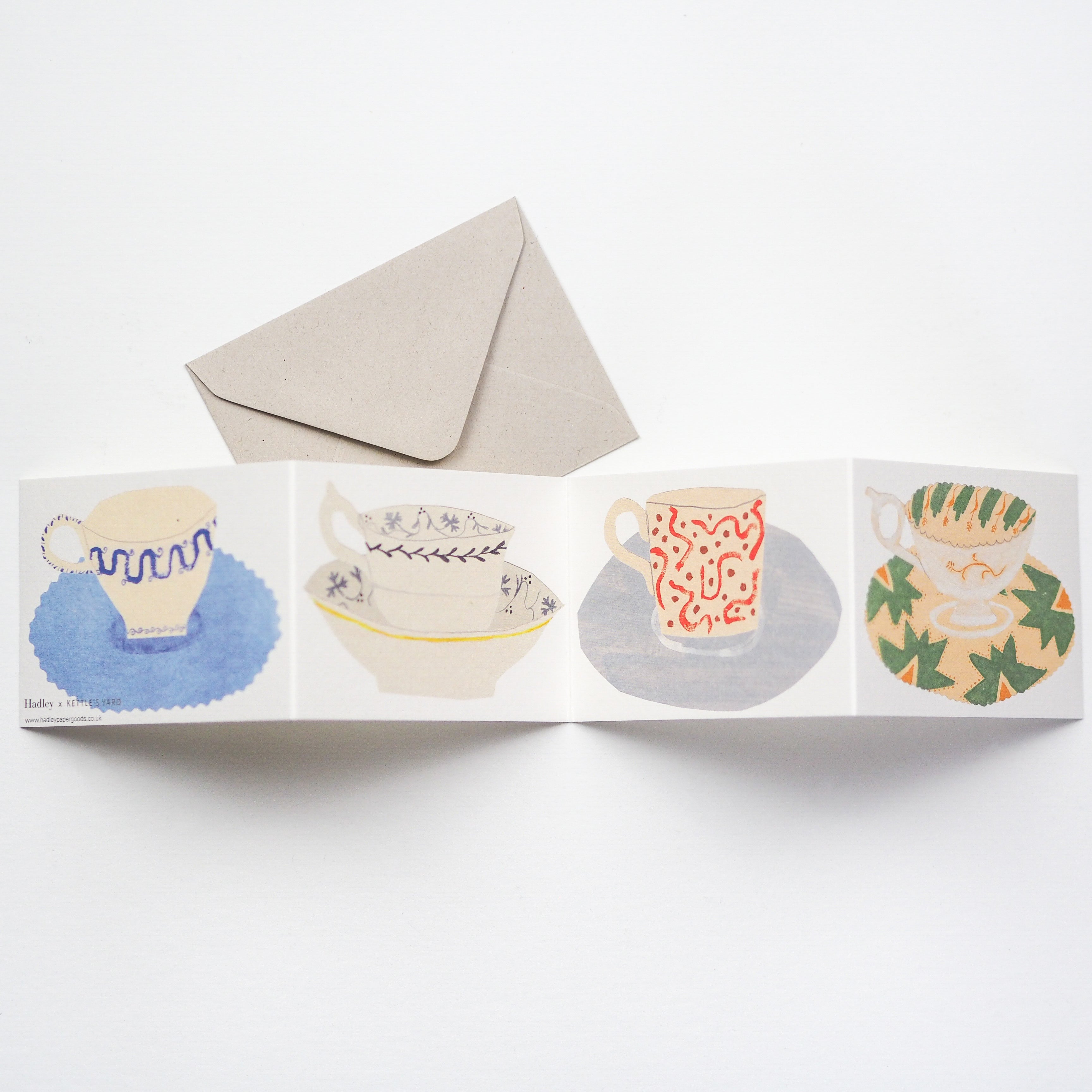 A card that unfolds to reveal four beautifully illustrated cups and saucers.
